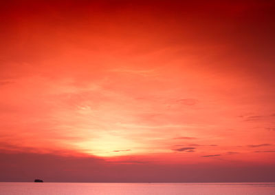 Scenic view of sea against dramatic sky during sunset