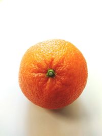 Close-up of orange apple against white background