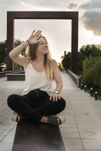 Full length of woman sitting on floor