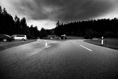 Vehicles on road against sky