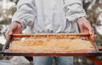 Midsection of man working on table