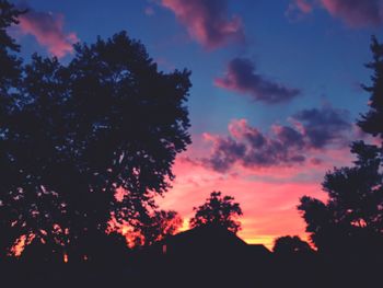 Silhouette trees against sky at sunset