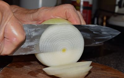 Detail shot of hand chopping onion