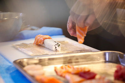 Cropped hand preparing food