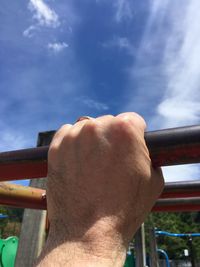 Close-up of woman hand against sky