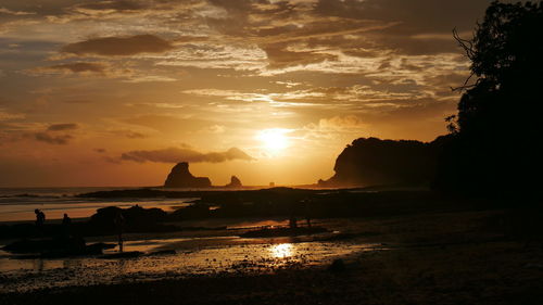 Scenic view of beach against sky during sunset