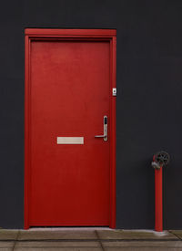Red closed door of building