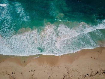 High angle view of waves rushing towards shore