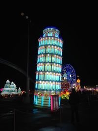 Illuminated ferris wheel at night