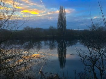 Scenic view of lake against sky at sunset