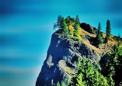 Rock formations in sea against sky