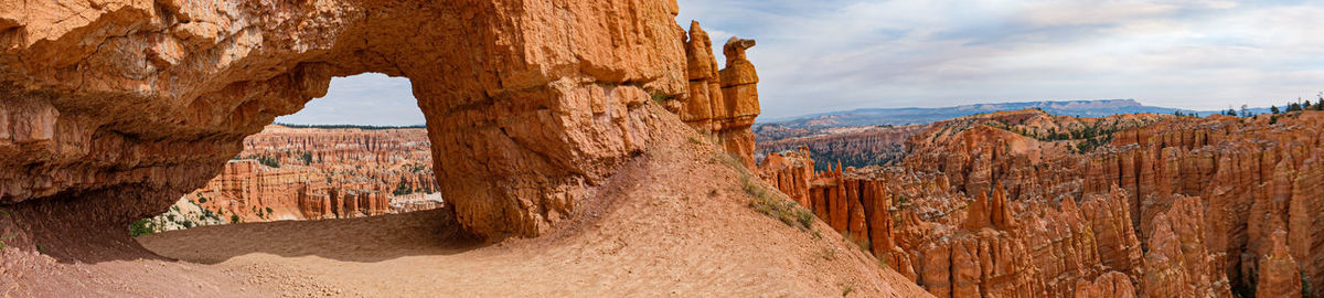 Panoramic view of rock formations against sky