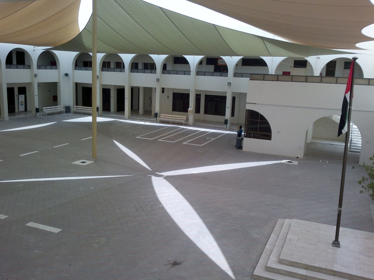 EMPTY PARKING LOT AGAINST BUILDINGS