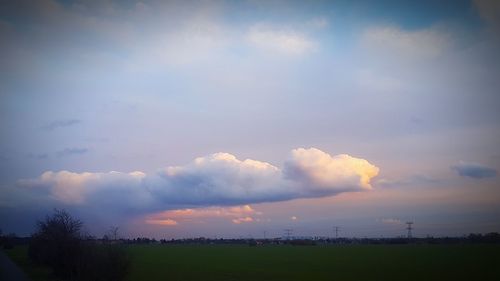 Scenic view of field against sky at sunset