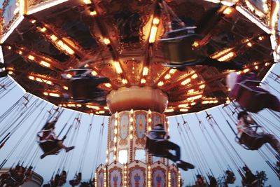 Low angle view of illuminated carousel at night