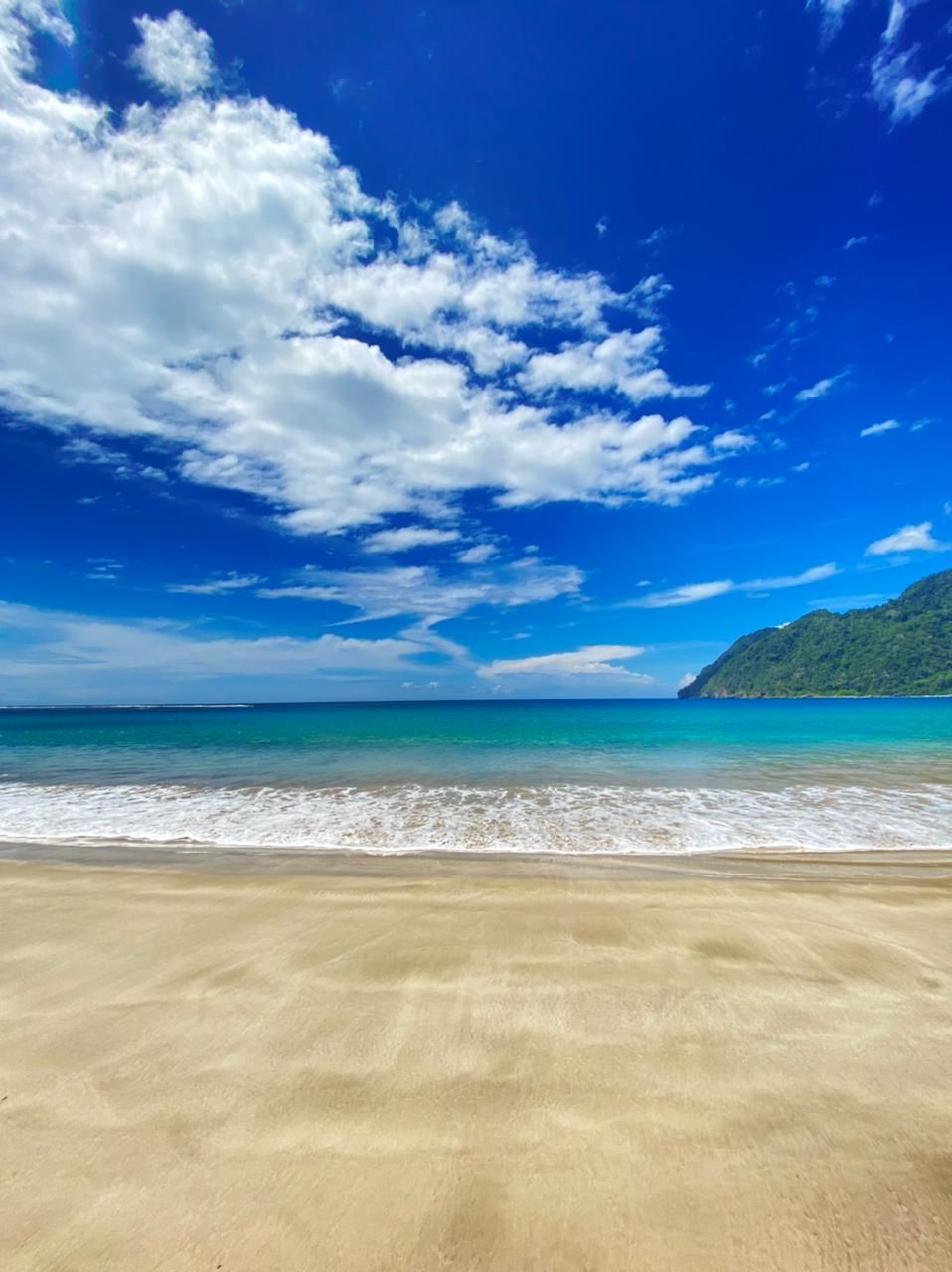 land, sea, sky, beach, water, scenics - nature, cloud, sand, beauty in nature, body of water, nature, shore, ocean, horizon, blue, environment, wind wave, travel destinations, landscape, tranquility, coast, travel, holiday, tranquil scene, trip, horizon over water, vacation, wave, summer, water's edge, tropical climate, no people, tourism, coastline, outdoors, idyllic, seascape, day, motion, island, water sports, sunlight, cloudscape, sports, sunny, bay