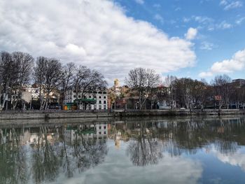 Reflection of trees and buildings in lake