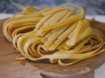 Close-up of raw tagliatelle on cutting board