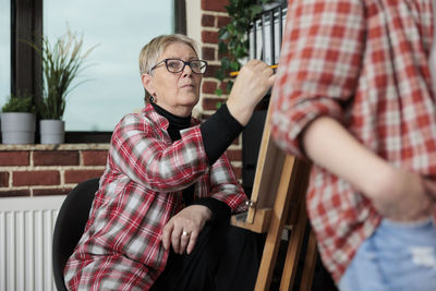 Senior woman practicing during drawing class