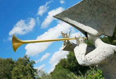 Low angle view of statue against blue sky