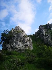 Low angle view of rocks on land against sky