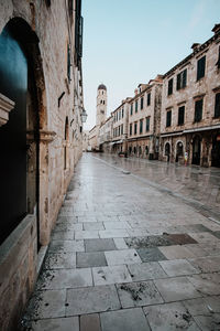 View of alley amidst buildings in city