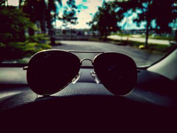 Close-up of sunglasses on road