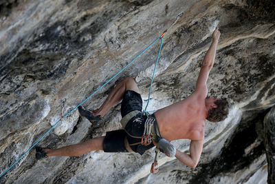 Midsection of person on rock at mountain