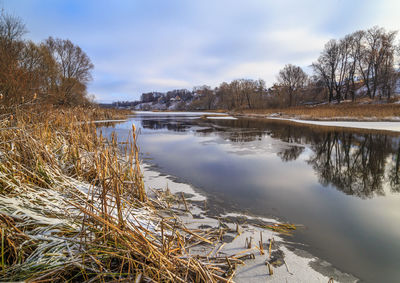 Scenic view of lake against sky during winter