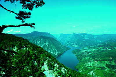 Scenic view of sea and mountains against sky