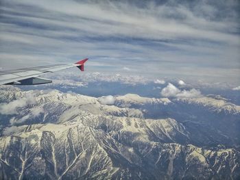 Cropped image of airplane flying over landscape