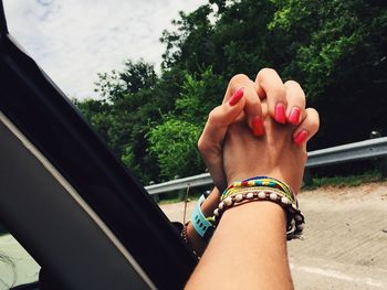 Close-up of woman hands outside car