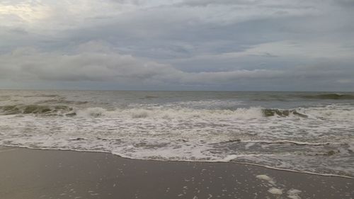 Scenic view of sea against cloudy sky