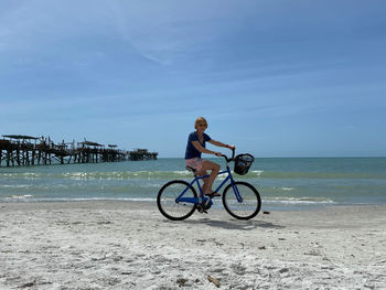 Man riding bicycle on beach