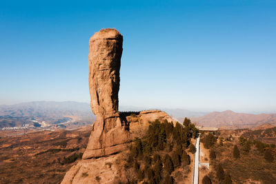 Rock formations on landscape against sky