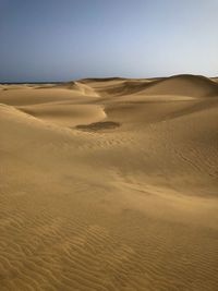 Scenic view of desert against clear sky