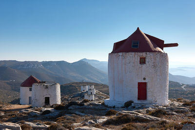 Buildings against mountains and sky