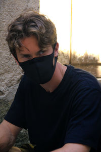 Portrait of young man sitting outdoors