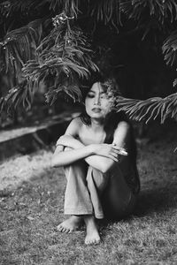 Portrait of young woman sitting outdoors