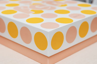 White cardboard box with colored circles