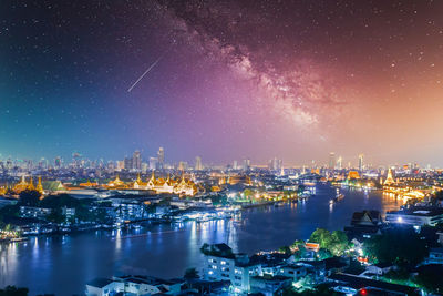 High angle view of illuminated buildings against sky at night