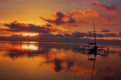 Scenic view of lake against orange sky