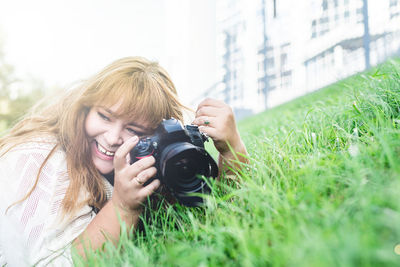 Body positive. portrait of overweight woman taking pictures with a camera in the park