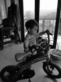 Boy playing with bicycle at home