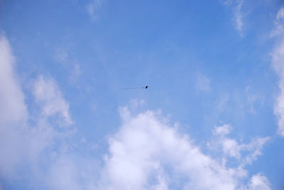 Low angle view of airplane flying in sky