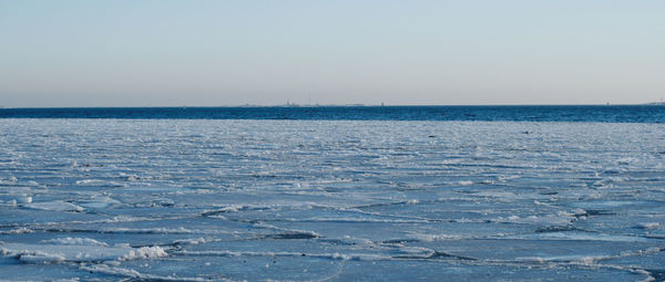 Scenic view of sea against clear sky during winter