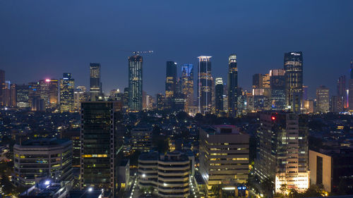 Aerial view of illuminated buildings in city at night