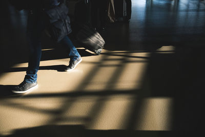 Low section of person walking in airport terminal