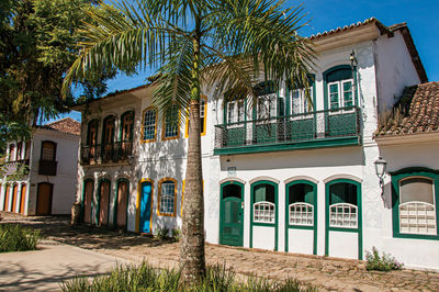 Old colored houses, palm tree and cobblestone in paraty, brazil