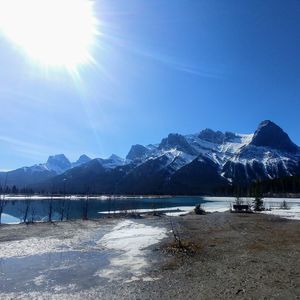Scenic view of snowcapped mountains against blue sky
